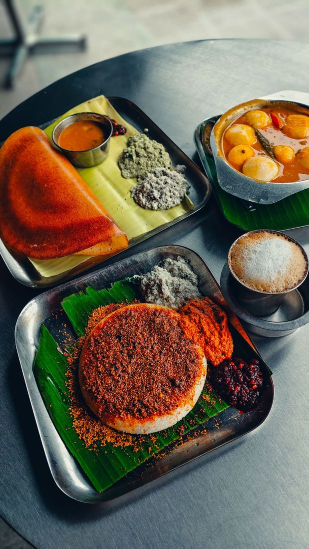 South Indian breakfast spread with dosa, idli and coffee