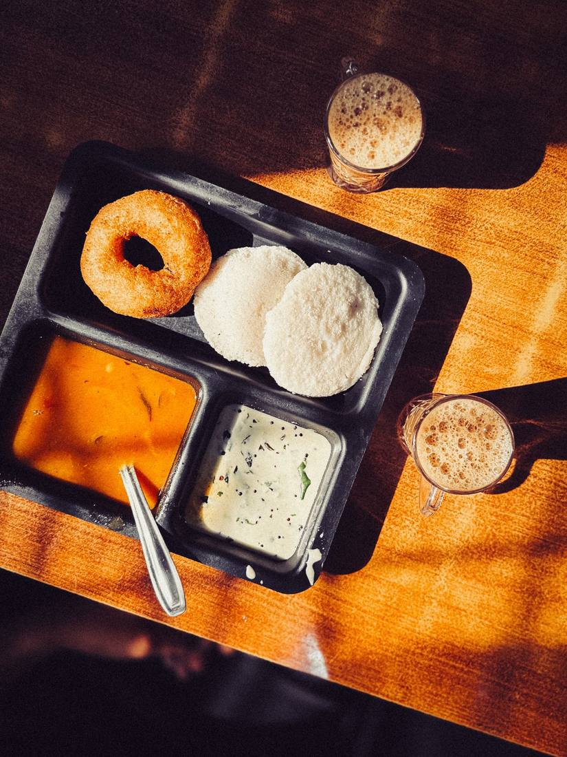 Idli vada tray with chutneys and coffee