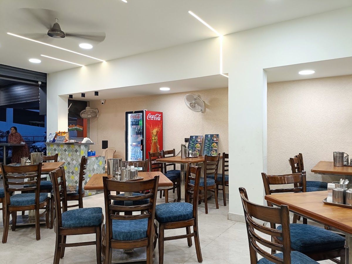 Dining room with wooden tables and blue chairs