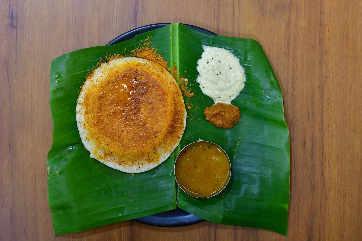 Set dosa on banana leaf with sambhar