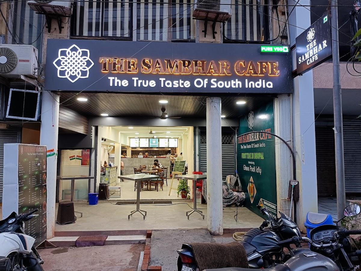 The Sambhar Cafe storefront in MP Nagar with its black and white sign